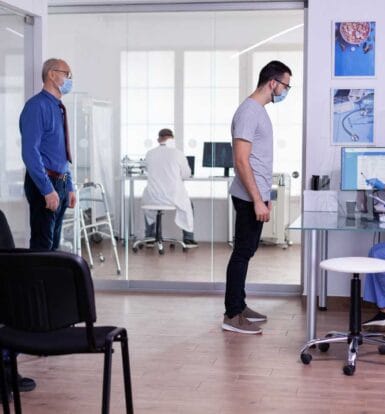 Medical coding specialists working on a computer at a Maine hospital.