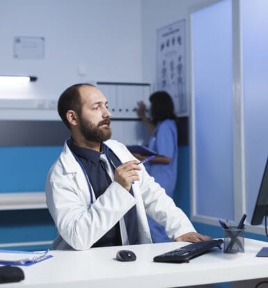 A medical scribe assisting a physician during patient care in New Jersey.