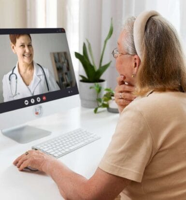 Senior patient interacting with a healthcare provider during a virtual consultation, highlighting the benefits of remote patient support.