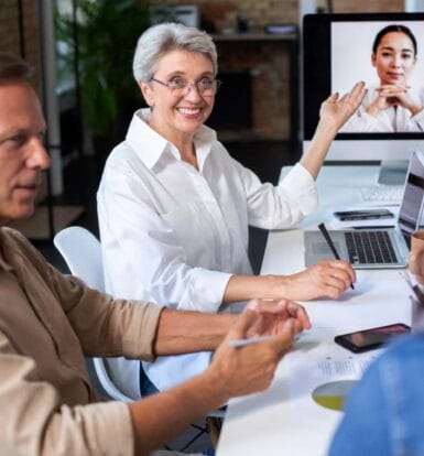 Healthcare professionals collaborating with virtual teams during a remote meeting, showcasing efficiency and teamwork in healthcare.