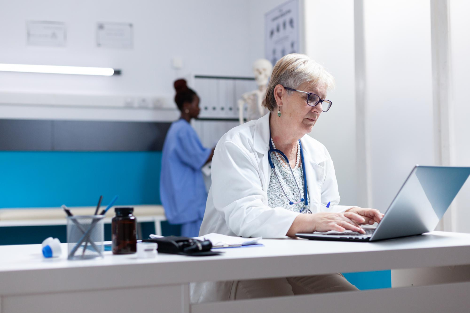 A medical coder reviewing patient records at a Massachusetts clinic.