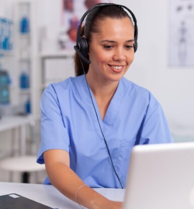 "Virtual receptionist supporting healthcare practice with headset and laptop"