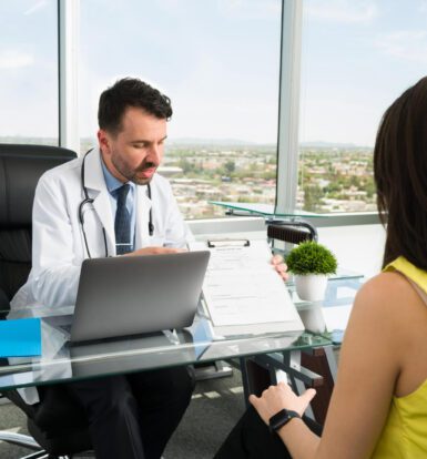 Doctor using a remote medical scribe for EHR documentation.