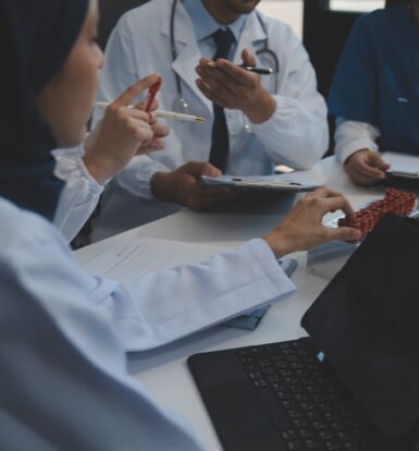 A healthcare professional reviewing compliance documents on a tablet, ensuring adherence to healthcare compliance best practices.