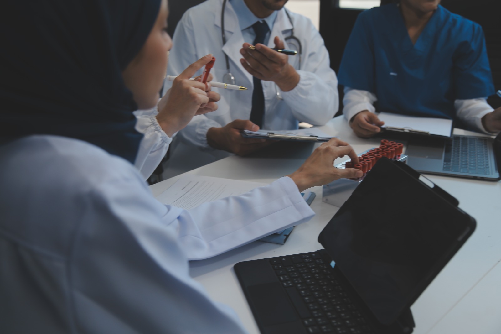 A healthcare professional reviewing compliance documents on a tablet, ensuring adherence to healthcare compliance best practices.