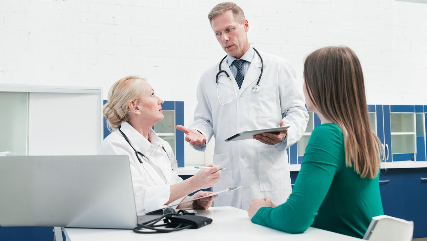 Healthcare professional using advanced medical devices alongside virtual medical assistant tools, illustrating improved patient care and operational efficiency through outsourcing.