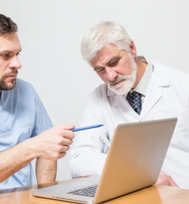 A healthcare researcher analyzing medical coding data on a computer screen.