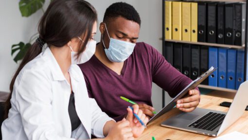 A healthcare professional analyzing medical coding data on a computer screen.