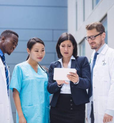 A medical scribe assisting a doctor in a hospital setting.