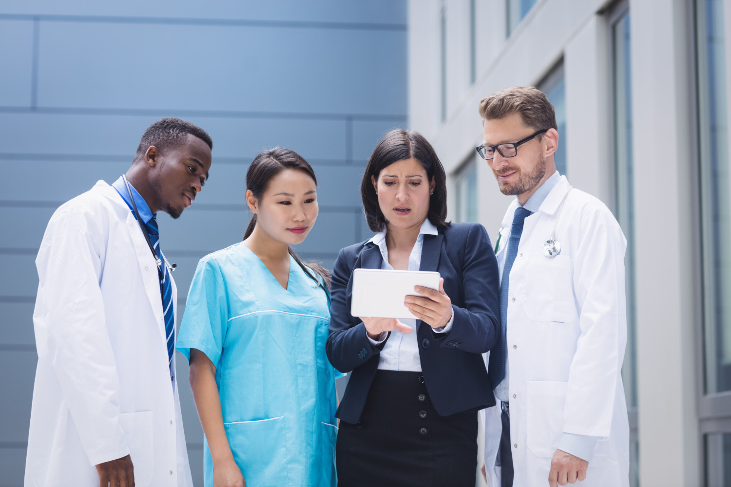 A medical scribe assisting a doctor in a hospital setting.