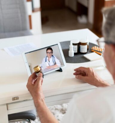 Senior patient consulting a doctor online via a virtual patient coordinator for medication guidance.