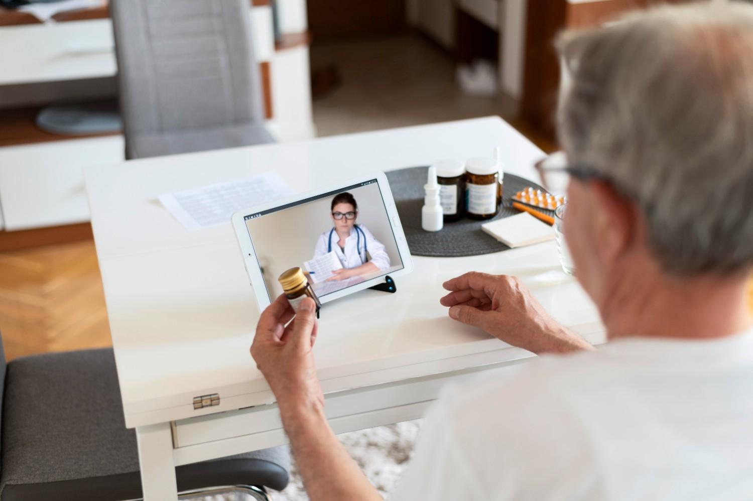 Senior patient consulting a doctor online via a virtual patient coordinator for medication guidance.