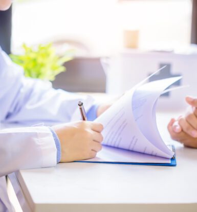 Doctor helping patient with medication access paperwork for CoverMyMeds