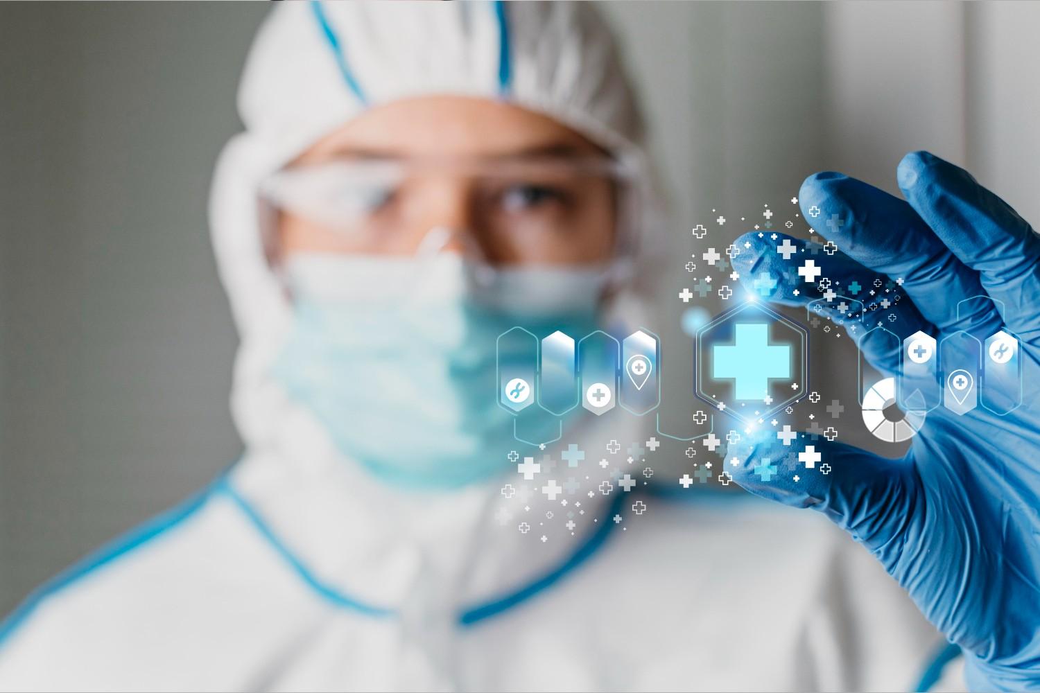 Healthcare professional in protective gear holding a digital medical interface symbolizing HIPAA compliance and data security.