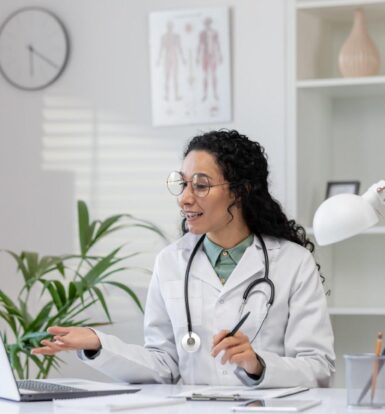 Female doctor using a laptop for a virtual consultation, representing the benefits of a Virtual Medical Assistant for Work-Life Balance.